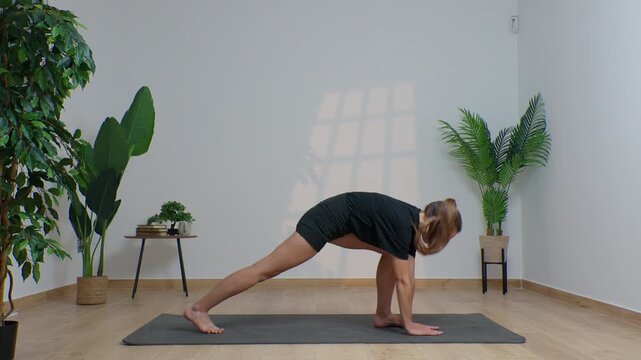 High-definition footage of a female instructor performing a variety of full-body yoga poses on a bright, neutral backdrop. Clean, minimalist composition and soft studio lighting highlight balance, fle