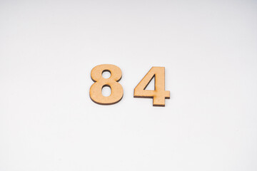 Number eighty-four on paper on a white background.