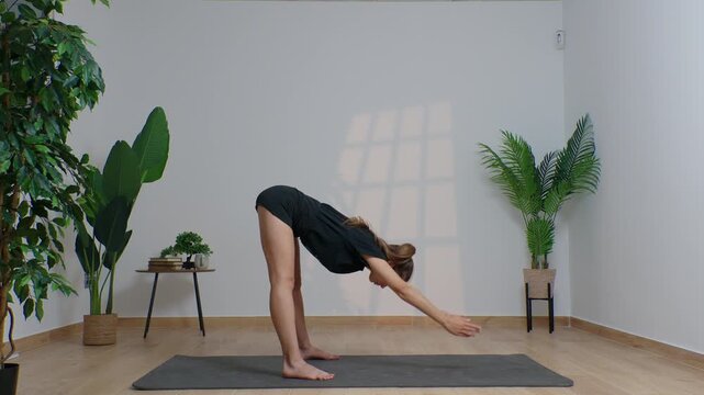 High-definition footage of a female instructor performing a variety of full-body yoga poses on a bright, neutral backdrop. Clean, minimalist composition and soft studio lighting highlight balance, fle