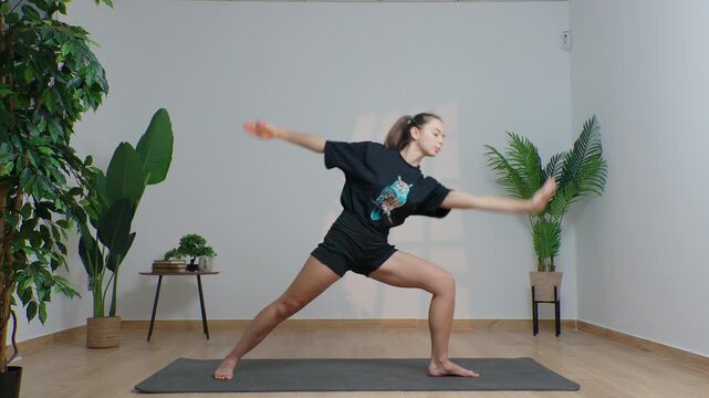 High-definition footage of a female instructor performing a variety of full-body yoga poses on a bright, neutral backdrop. Clean, minimalist composition and soft studio lighting highlight balance, fle