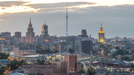 Ostankino tv tower and stalin skyscrapers near railway station day to night timelapse. Moscow,...