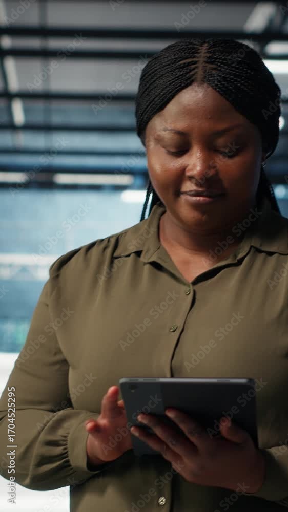 Aufkleber vertical video data center software developer monitors data center metrics on tablet to enhance oper