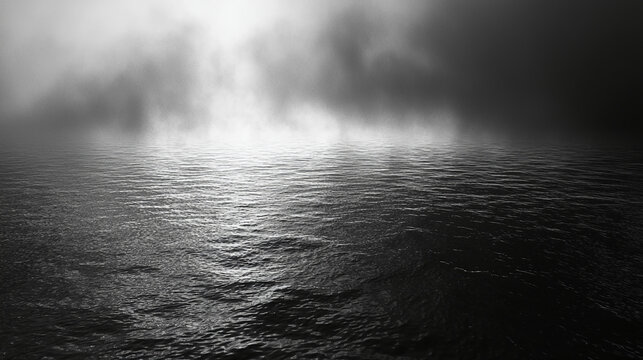 A serene black and white image of a foggy body of water, reflecting light with a mysterious ambiance.