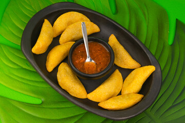 Delicious traditional Colombian empanadas with spicy sauce