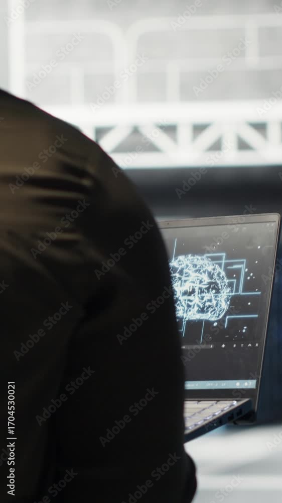 Poster vertical video computer scientist doing data center automation using ai on laptop. server room it sp