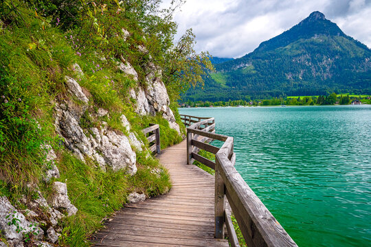 Small wooden footbridge and hiking path on the shores of Lake Wolfgang (Wolfgangsee) in the Salzkammergut, Austria