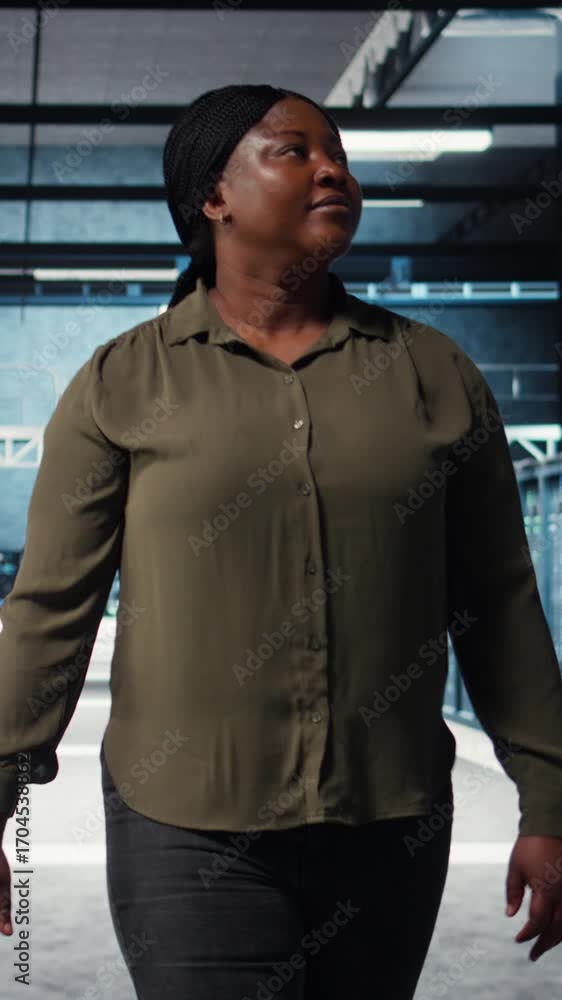Poster Vertical video Supervisor in data center overseeing large scale IT equipment to maintain seamless operations. IT expert walking between server room rows, doing network management for increased uptime