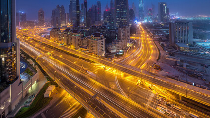 Dubai downtown skyline night to day aerial timelapse with traffic on highway
