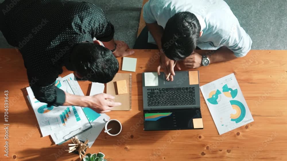 Aufkleber top aerial view of business team working together to analysis data by using laptop on meeting table.