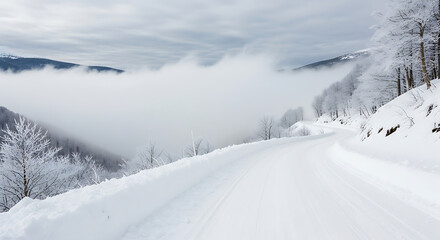 Winter mountain road covered in snow with clouds creating a mystical atmosphere