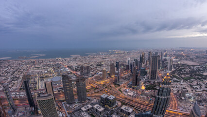Obraz premium Downtown of Dubai night to day timelapse before sunrise. Aerial view with towers and skyscrapers