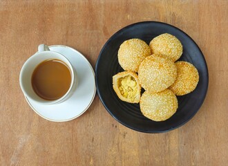 coffee and cookies,Sesame balls or Onde onde or Jiandui or Kue moci or Kuih bom,a type of Chinese pastry,made from glutinous rice,coated with sesame seeds,filled with a filling usually beans,served wi