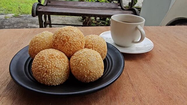 coffee and cookies,Sesame balls or Onde onde or Jiandui or Kue moci or Kuih bom,a type of Chinese pastry,made from glutinous rice,coated with sesame seeds,filled with a filling usually beans,served wi