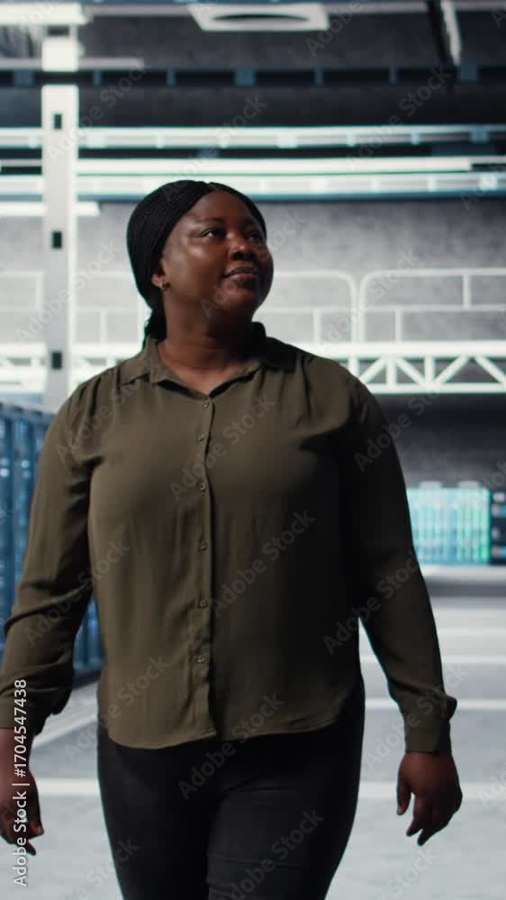Poster vertical video engineer walking in data center, checking hardware for system stability. employee ove