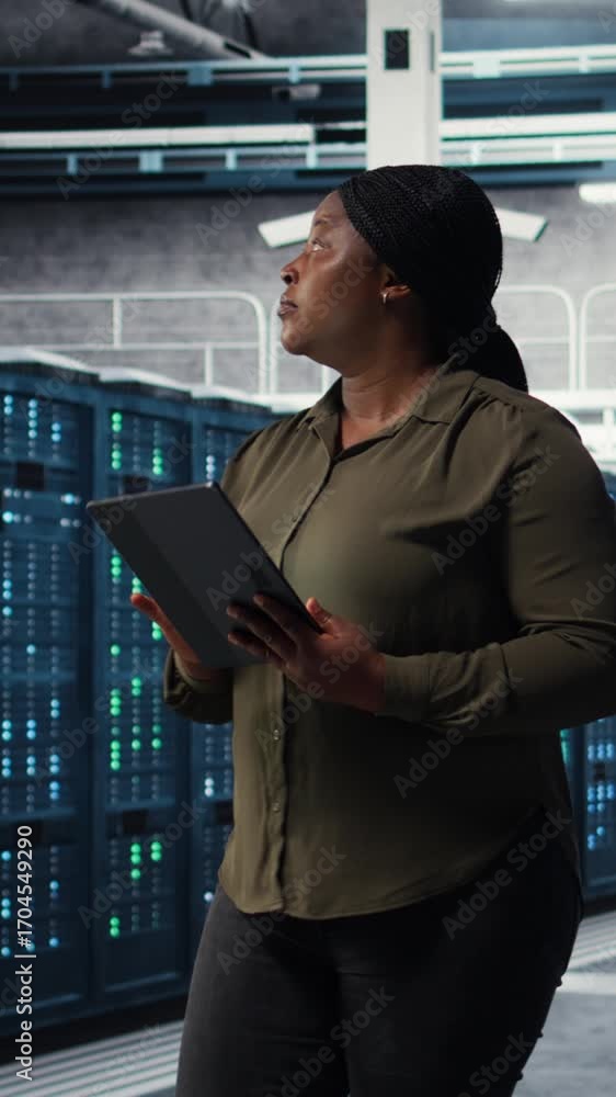 Aufkleber vertical video data center admin monitoring data center metrics on tablet to enhance operational eff