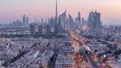 Obraz premium Dubai skyline after sunset with beautiful city center lights and Sheikh Zayed road traffic timelapse, Dubai, United Arab Emirates