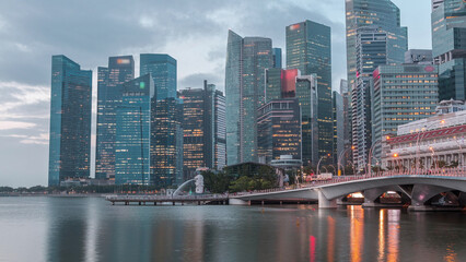 Esplanade bridge and downtown core skyscrapers in the background Singapore night to day timelapse