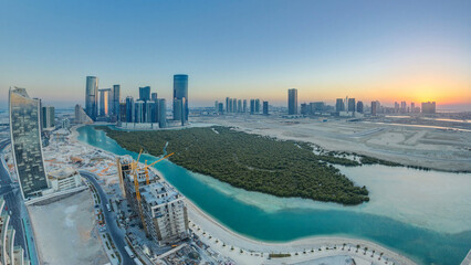 Buildings on Al Reem island in Abu Dhabi at sunset timelapse from above. © HyperlapsePro