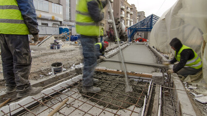 Pouring ready-mixed concrete after placing steel reinforcement to make the road by concrete mixer...