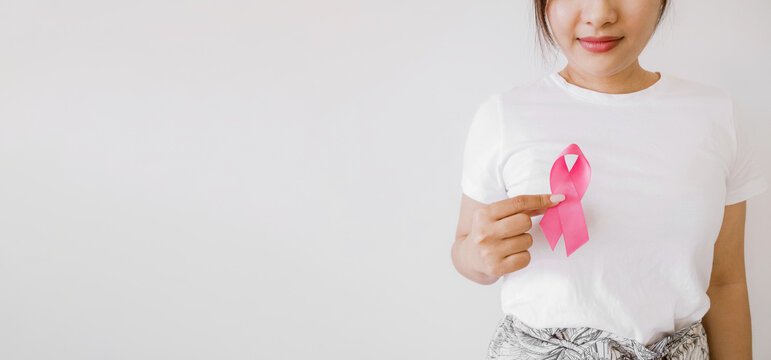 Woman hands holding pink ribbons, Breast cancer awareness and October Pink day, world cancer day
