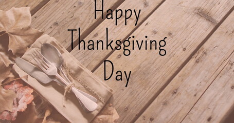 Fototapeta premium Image of happy thanksgiving day text over cutlery on wooden background