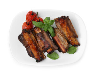 Roasted beef ribs, tomatoes and basil isolated on white, top view