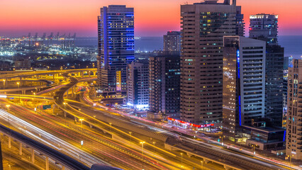 Fototapeta premium Dubai marina with traffic on sheikh zayed road panorama day to night timelapse lights turn on.