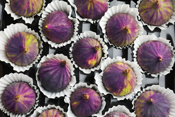 Fresh ripe figs in plastic container, top view