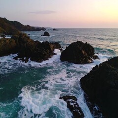 Obraz premium Coastal rocks and waves at sunset