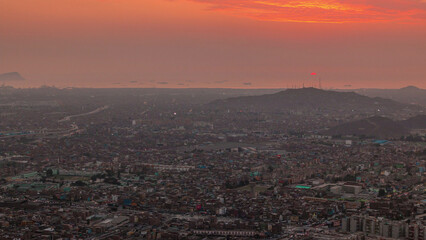 Fototapeta premium Aerial sunset view of Lima skyline timelapse from San Cristobal hill.