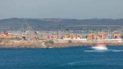 Fototapeta premium Aerial view of container cargo terminal of commercial port timelapse, business logistics and transport industry in Sines, Portugal.