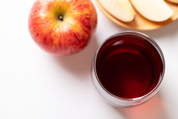 Glass of apple cider with red apple fruit on white background, Top view