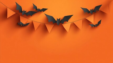 Spooky halloween garland of black paper bats and orange triangular flags casting shadows on a bright orange background
