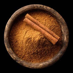 Dramatic Top-Down View of Aromatic Cinnamon Powder and Sticks in a Rustic Wooden Bowl.