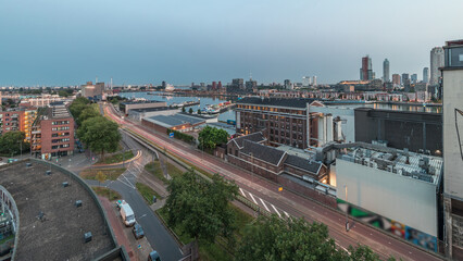 Obraz premium Aerial panoramic view over towers in Maashaven night to day timelapse in Rotterdam