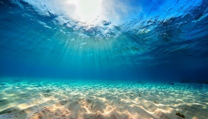 Obraz premium Bright Underwater Scene With Blue Water And Sun Rays Lighting Golden Sand On The Ocean Floor