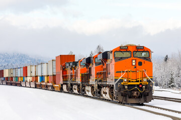 freight train pulling cargo near Whitefish, Montana on a frigid day in winter