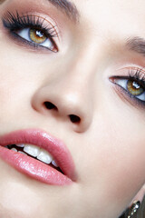 Closeup macro shot of human female face. Woman with eyes and lips beauty makeup