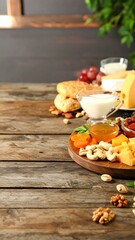 Assorted Cheese and Snacks on Rustic Wooden Table