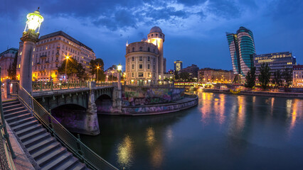 Naklejka premium Urania and Danube Canal day to night timelapse in Vienna.