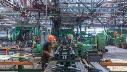 Conveyor assembly stage the body of tractor at big industrial factory timelapse