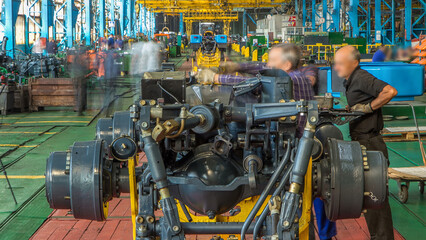 Conveyor assembly stage the body of tractor at big industrial factory timelapse