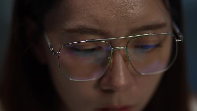 A cybersecurity analyst's glasses reflect a malicious script during a late-night forensic analysis of a network breach, representing data immersion and threat hunting.