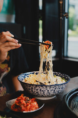 Grilled Korean beef short ribs (galbi) with caramelized edges on hot grill, served with lettuce wraps and kimchi, authentic Korean barbecue dining experience, overhead view.