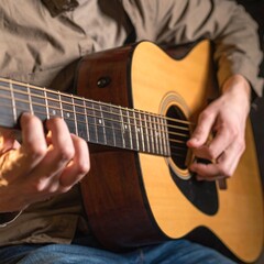 Fototapeta premium Person playing acoustic guitar