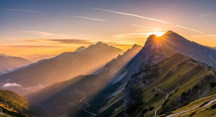 Majestic mountain range illuminated by dramatic sunrise with sun rays piercing through valleys