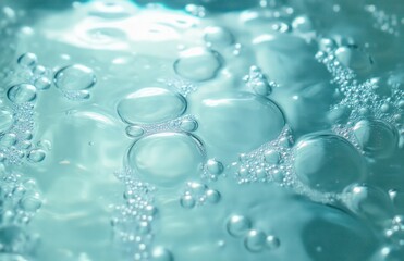 Close-up view of clear water surface with various sized bubbles floating and reflecting light in a blue tinted environment