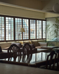Cozy living room interior with sofa, lamp, and lattice window