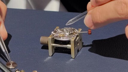 watchmaker's hands repair watch timepiece close up