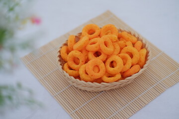 Pile of Cheese Puff Snacks in a Woven Basket